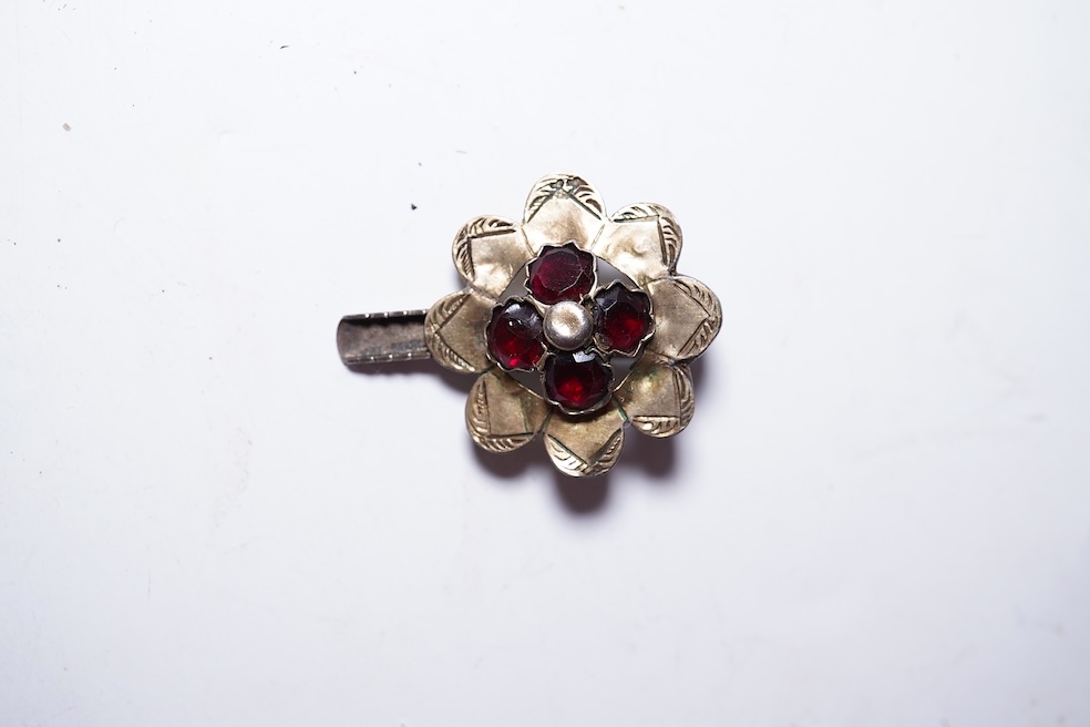 A suite of garnet and paste jewellery, comprising: a brooch, 5cm diameter; a bangle, inner circumference 16cm; two rings, sizes I and M; a pair of earrings, and a single earring, each set with rose-cut garnets; and a pai